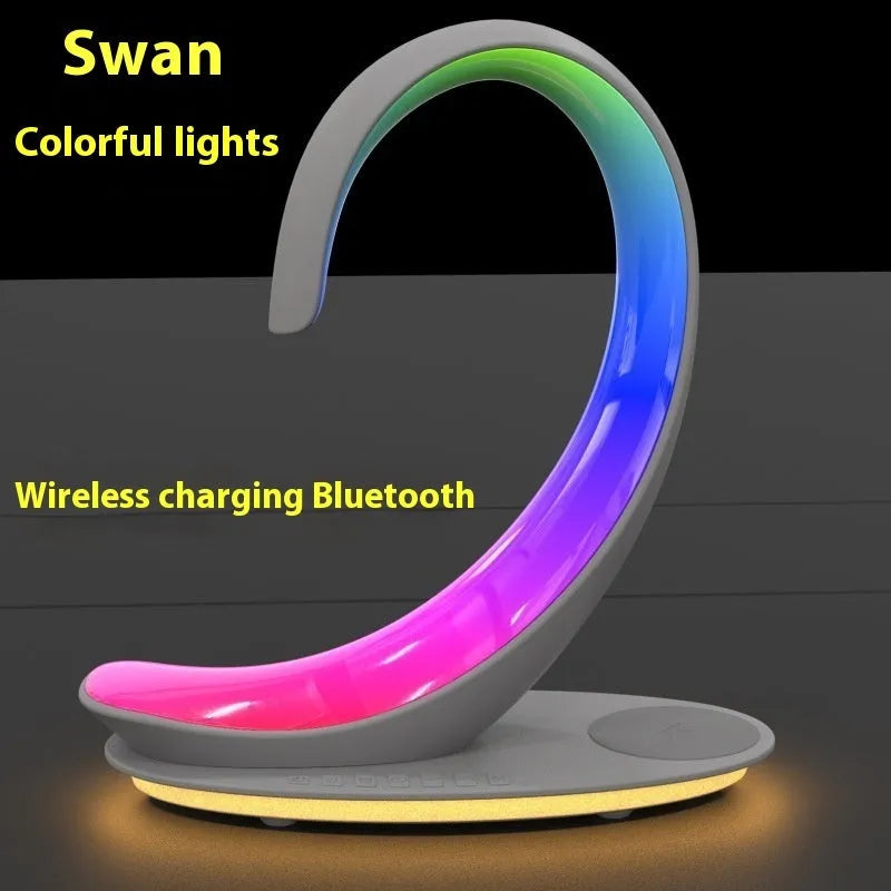 White swan-shaped desktop wireless charger with Bluetooth speaker and colourful atmosphere light