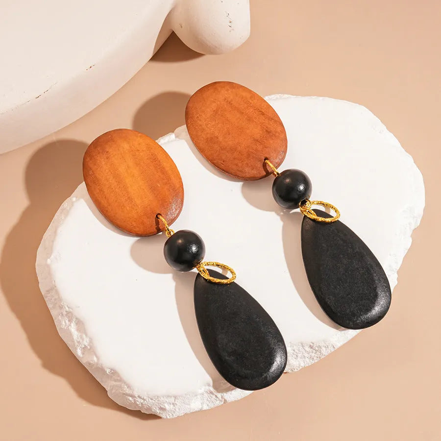 Wooden earrings with elliptical design in silver needle-brown-black colour scheme