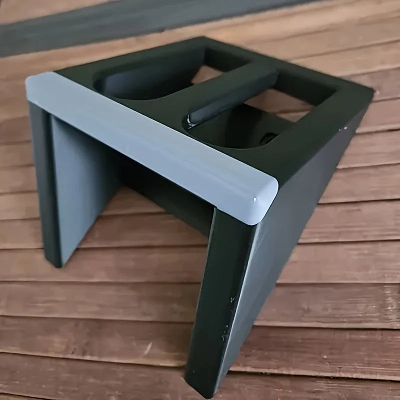 Black punk-style plastic stand for displaying a toy pistol.