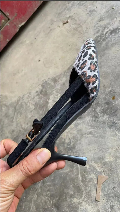 Leopard print suede women's sandals with pointed toe design on foot