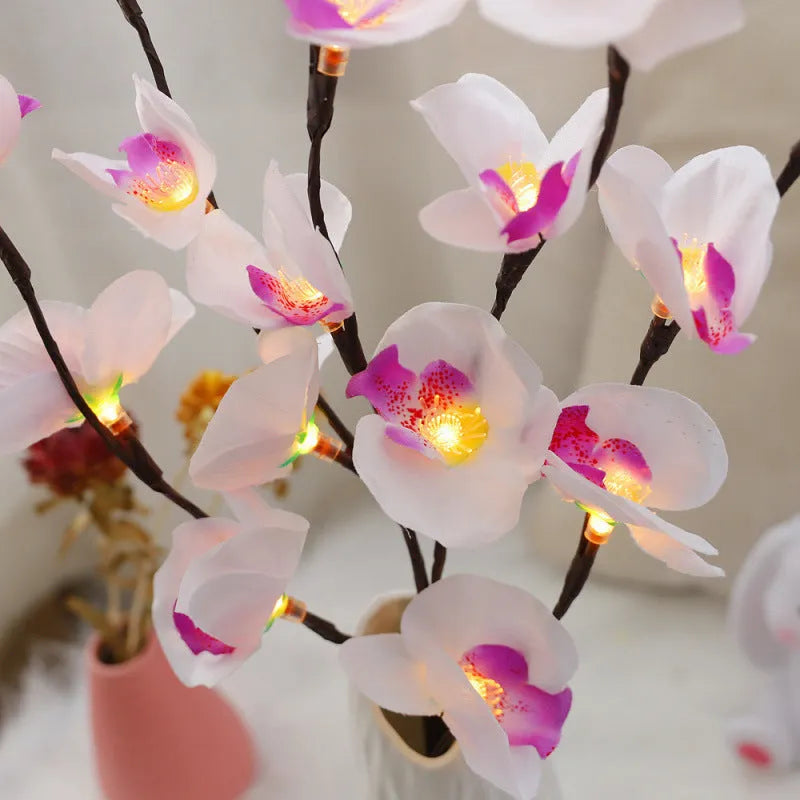 Pink LED phalaenopsis orchid branch decorative light with warm white LEDs on a 65cm stem.