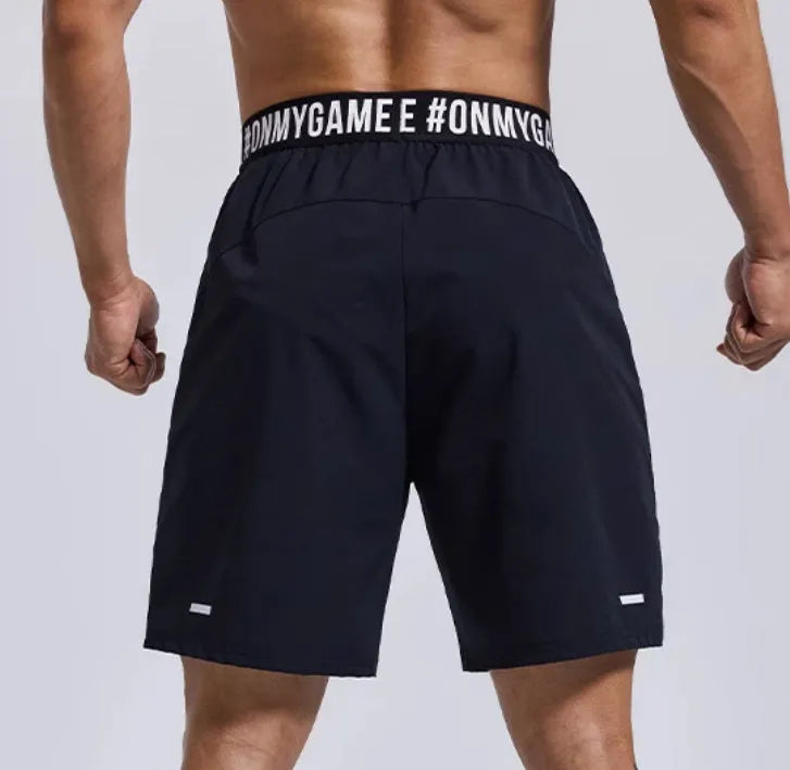 Man wearing loose grey sports shorts with an elastic waistband during a workout.