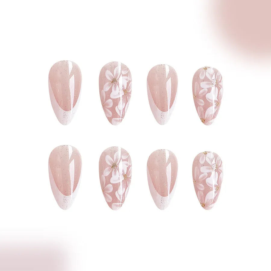 Short glossy almond French artificial nails with glittering powder flower decoration