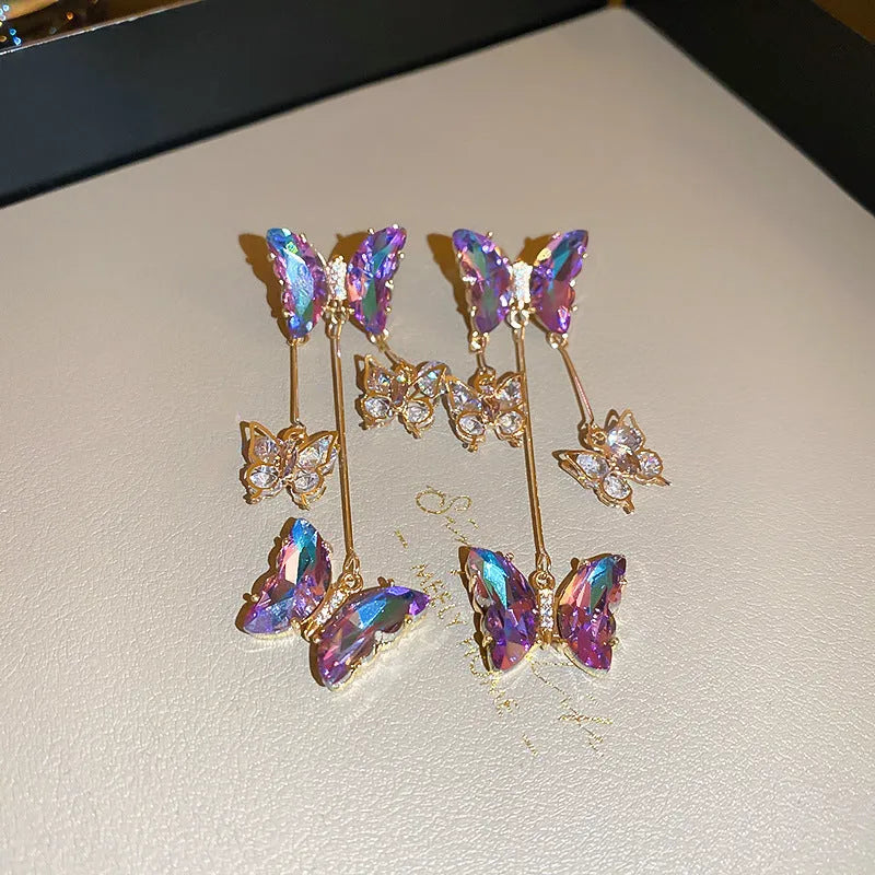 Blue purple alloy drop earrings with crystal flowers, butterfly design and tassel detailing