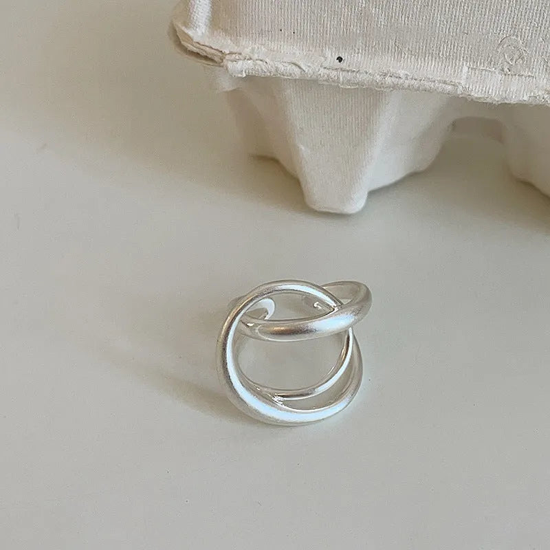 Geometric open ring with interlaced matte metal pattern in gold or silver electroplated finish