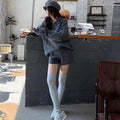 Women's creamy-white cable knit sweater and shorts set with an elastic waistband.