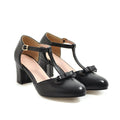 Women's apricot chunky heel sandals with a hollow-out round toe, T-strap buckle, and a black bow detail.