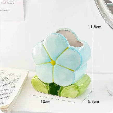 Ceramic flower pen holder storage box with floral design on desktop