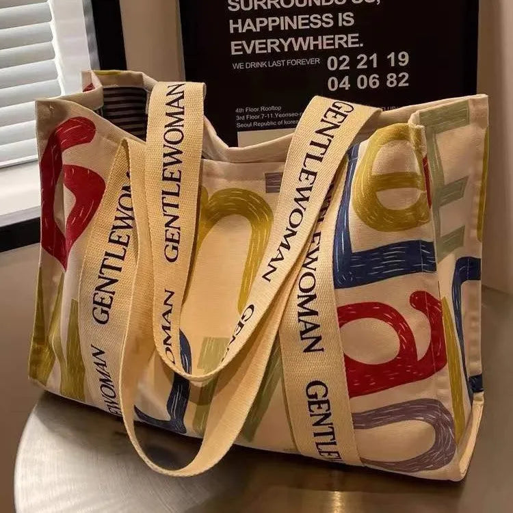 Large capacity canvas tote bag showing three design options: black letters, coloured letters, and pattern print