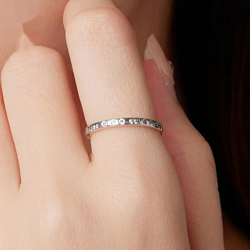 Moss Password I Love You oxidised black sterling silver ring on a simple bracelet band.