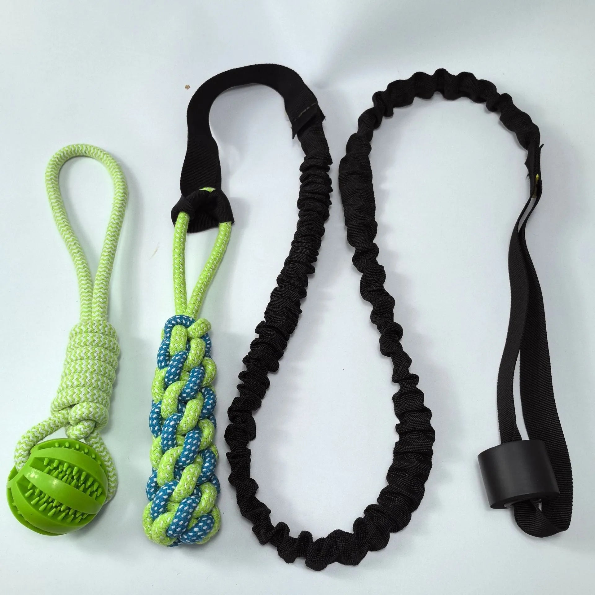 Green cotton rope dog toy with ball for tug of war and fetch games.