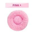 Fluffy grey donut dog bed with raised rim, shown with a small dog sleeping inside.