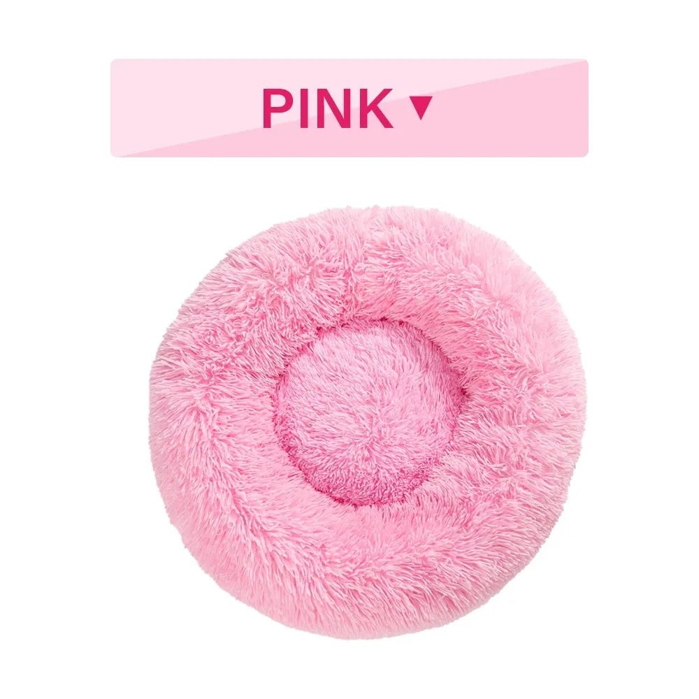 Fluffy grey donut dog bed with raised rim, shown with a small dog sleeping inside.