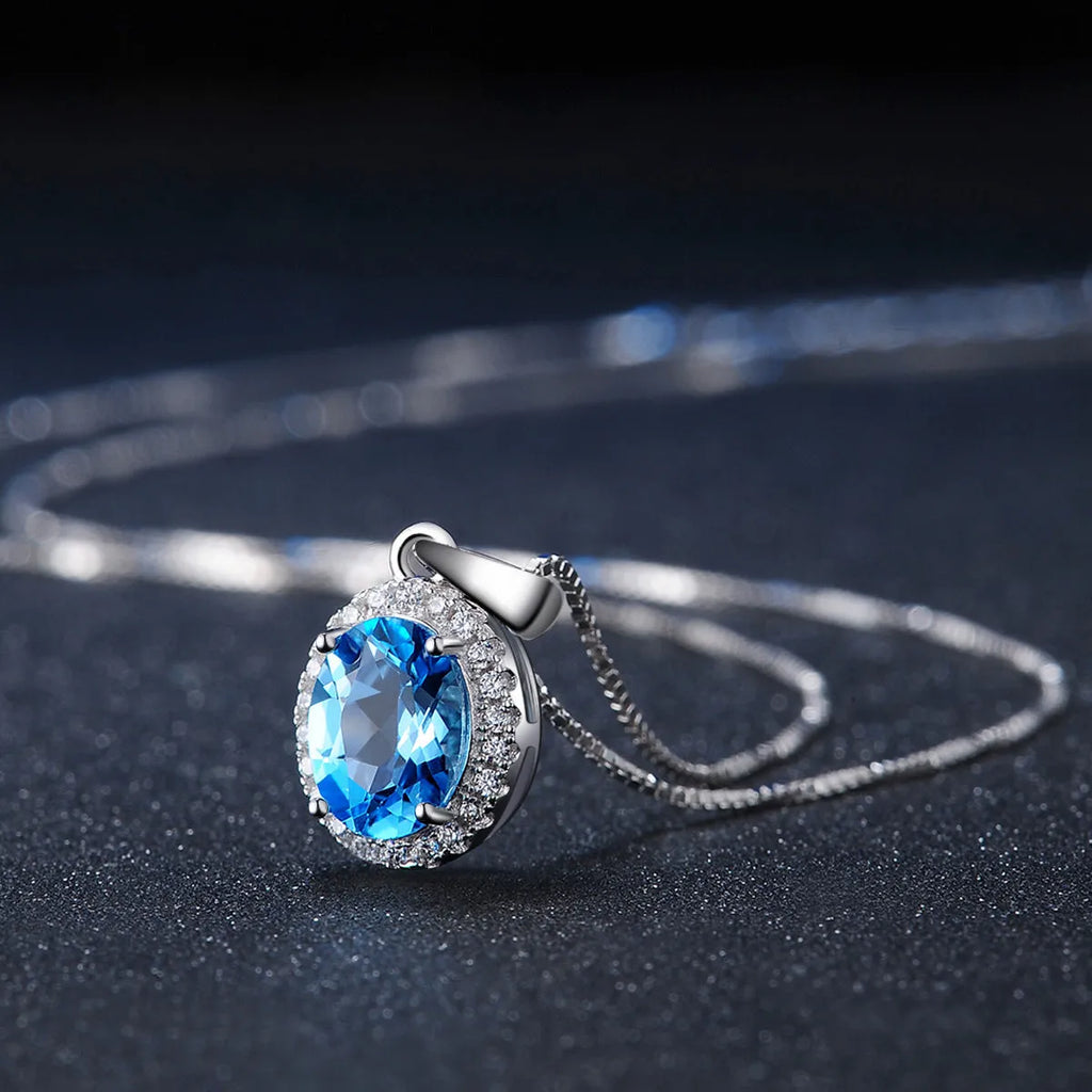 925 sterling silver jewellery set with blue topaz gemstones showing geometric design earrings, ring, pendant, and necklace