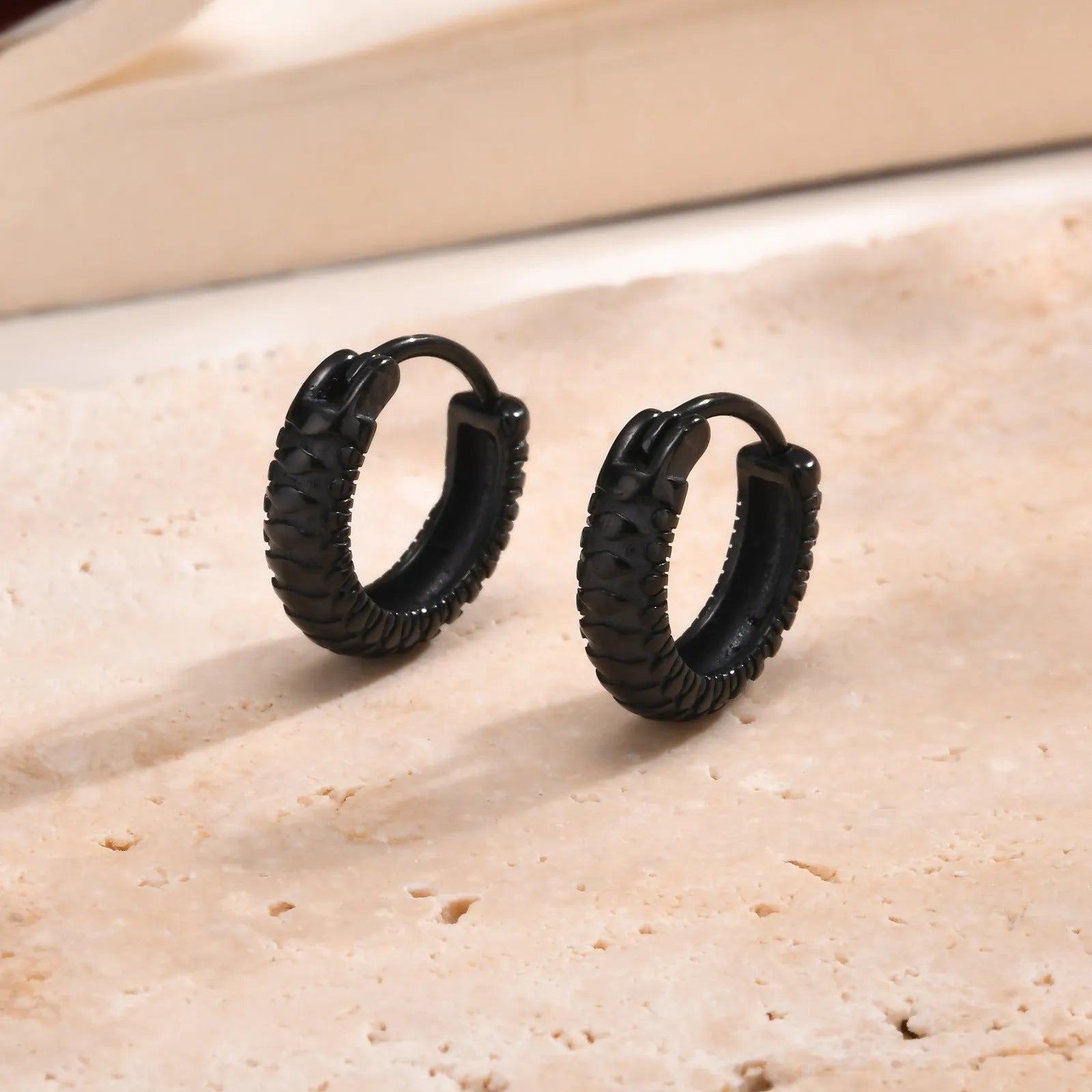 Stainless steel snake pattern stud earrings in black or gold finish