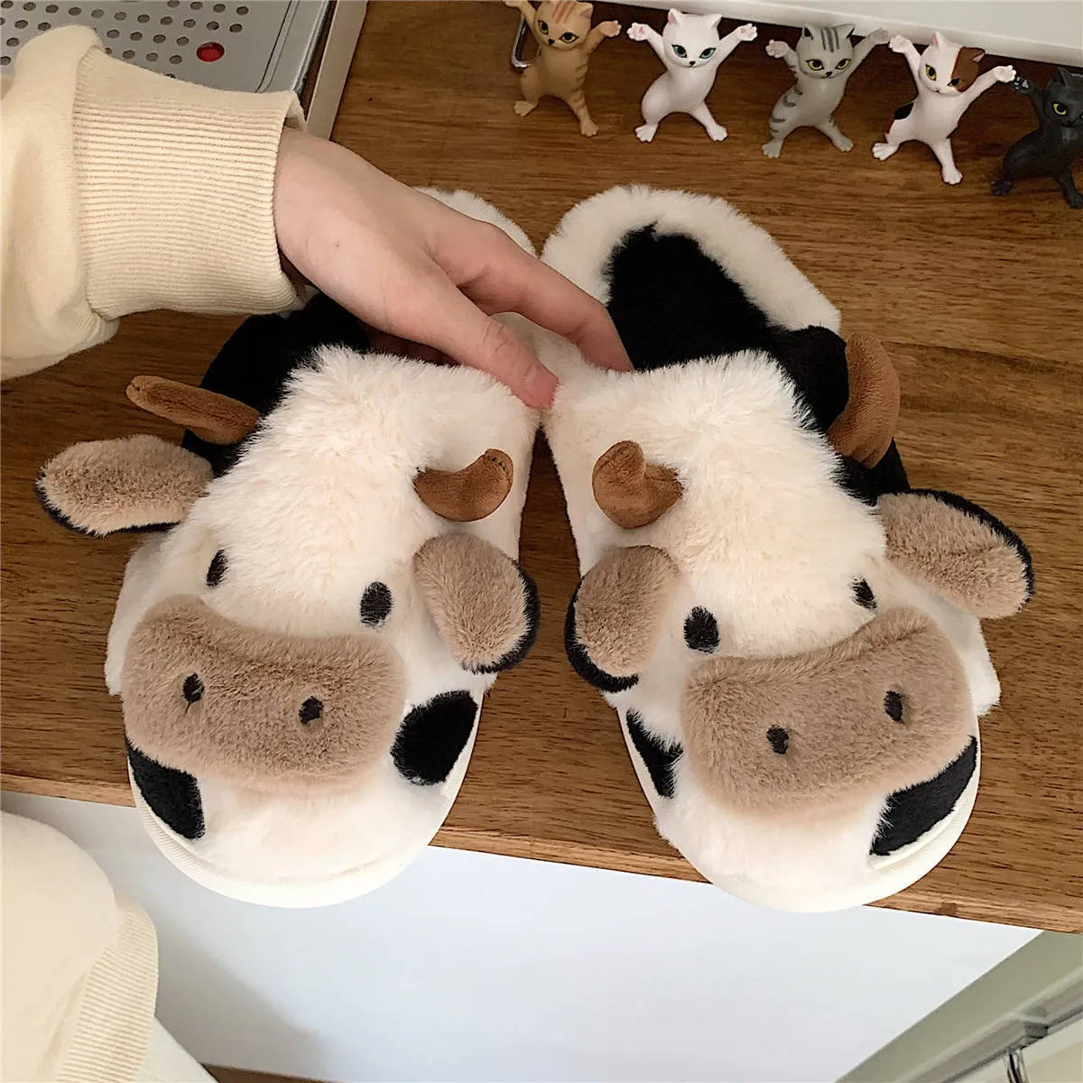 White women's cow slippers with plush faux fur upper and textured non-slip soles