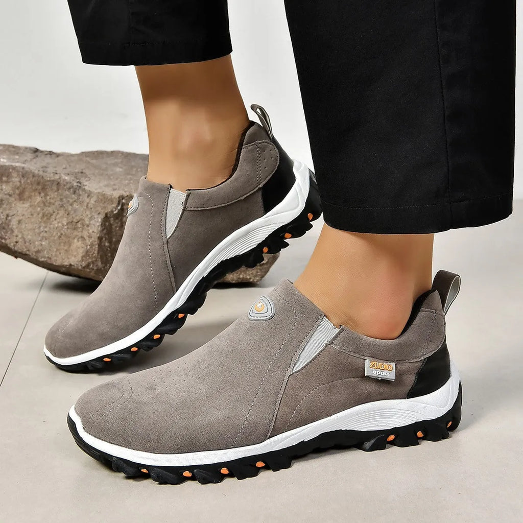 Men's thin grey overshoe cover with round toe and rubber sole, shown on a shoe.