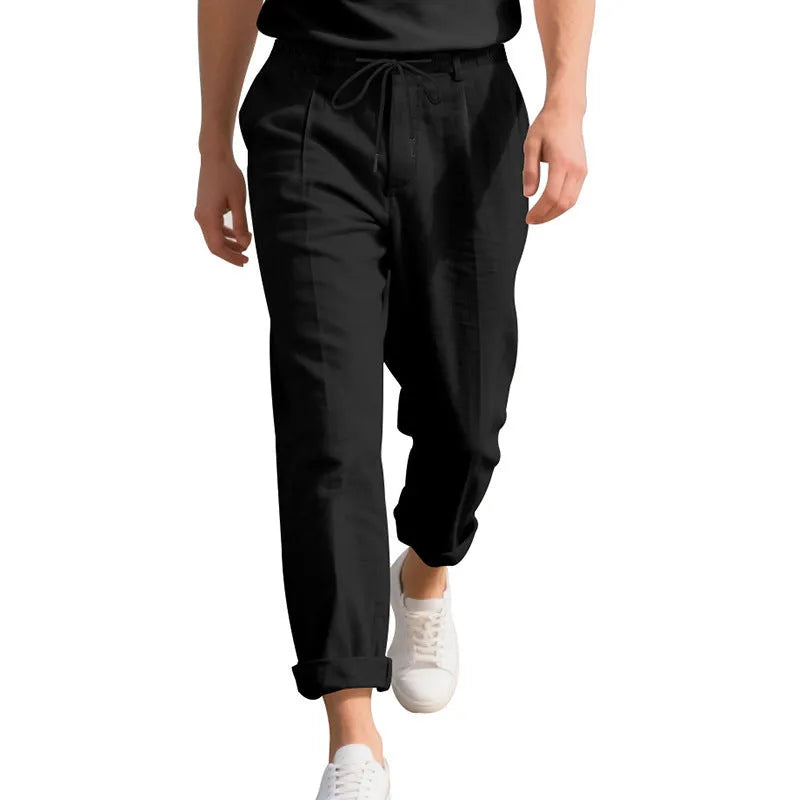 Men's light khaki linen casual trousers with drawstring waist and straight loose leg on hanger.