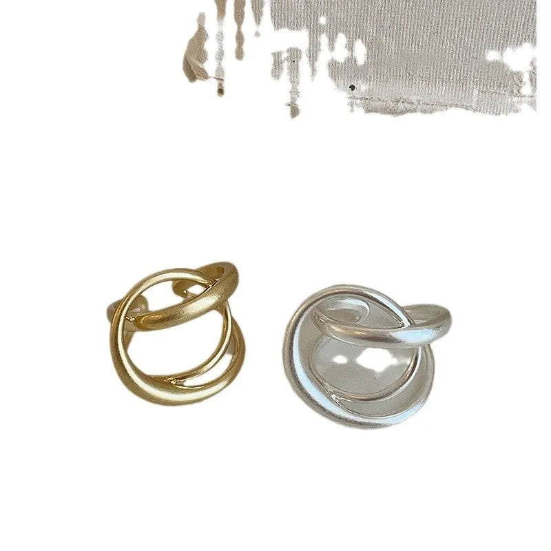 Geometric open ring with interlaced matte metal pattern in gold or silver electroplated finish