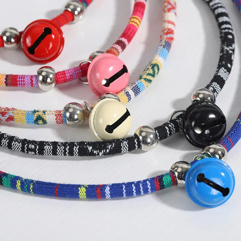 Colourful ethnic style adjustable dog collar with a bell, shown in multiple colour options.