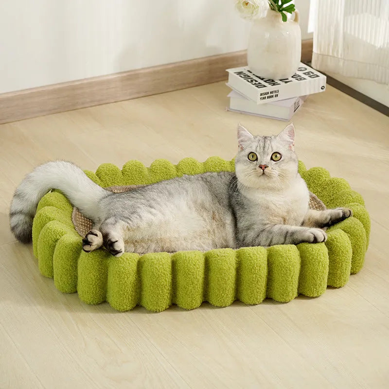 Green oval cat scratcher pad and bed made from sisal, measuring 65cm long.