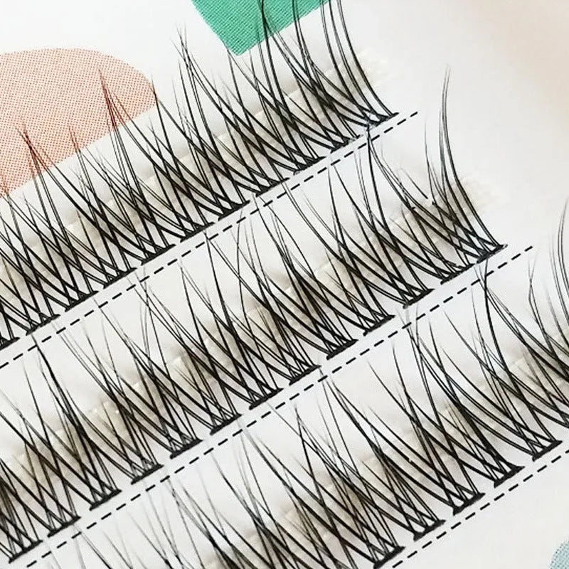 Black V-shaped fairy fishtail false eyelashes showing thick segment design on a clear band.