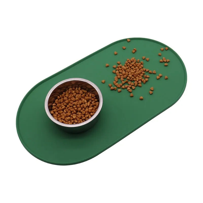 Green silicone waterproof placemat for cat bowls on a wooden floor