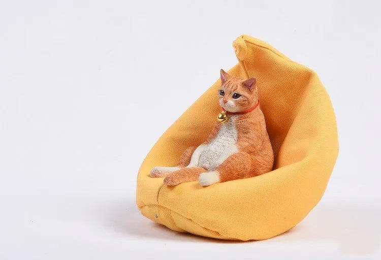Lazy cat and sofa miniature car ornament set on a dashboard, 7.5cm high.