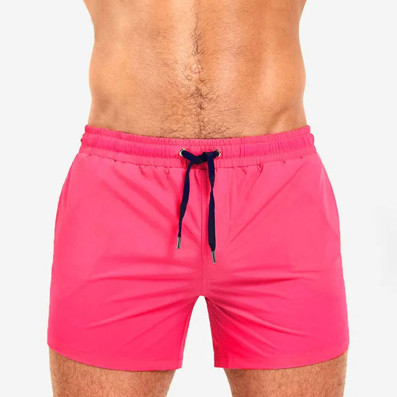 Mesh-lined sports shorts in polyester fabric with elastic waistband available in multiple colours