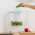 A blue plastic storage rack designed to hold a roll of kitchen bin bags.