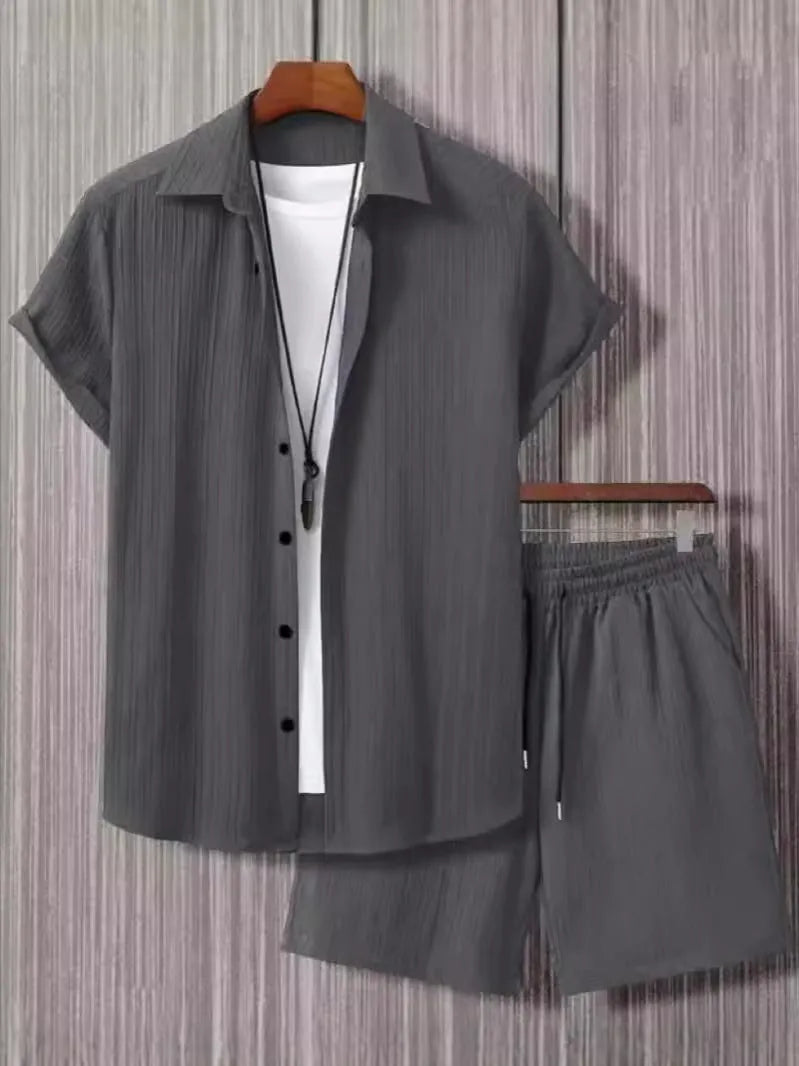 Man wearing a beige jacquard short sleeve suit jacket and matching shorts, a casual two-piece set.
