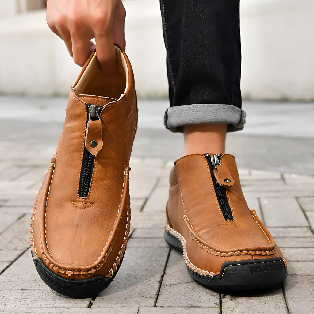 Men's solid colour slip-on loafers with round toe and rubber sole, shown in black, brown, and grey.