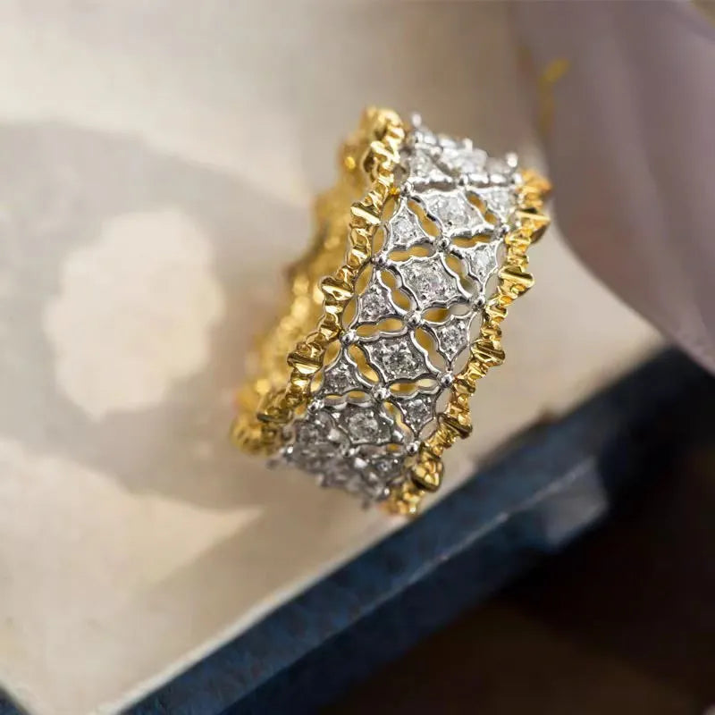 Gold and silver two-tone geometric zircon ring made from copper, showing a round design detail.