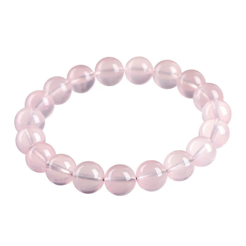 Natural Starlight Crystal round bead bracelet in pink, showing polished finish on wrist.