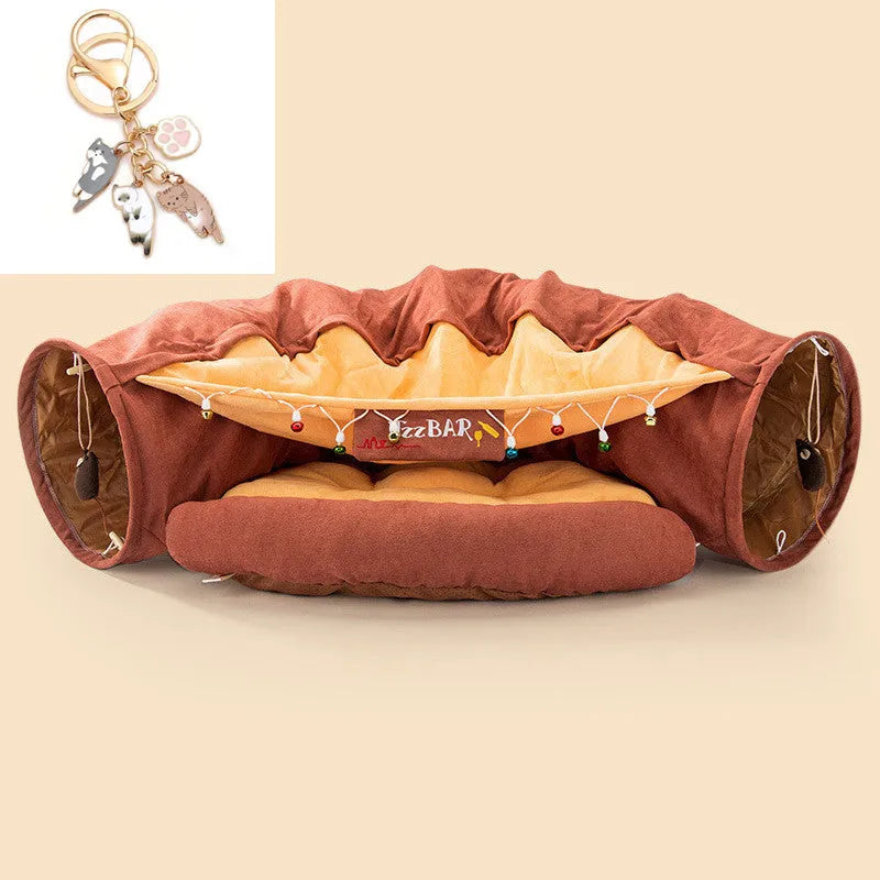 Collapsible cloth cat tunnel folded flat next to a cat, showing Coffee colour option.