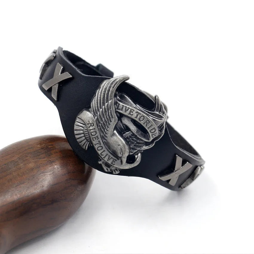 Black geometric leather bracelet with Eagle watch-button detail, showing tapered width.