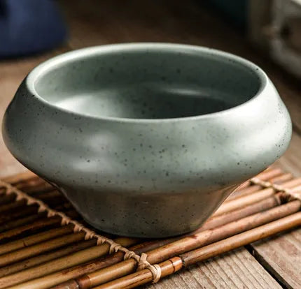 Ceramic tall Japanese soup noodle bowl in a retro glaze colour on a wooden table.