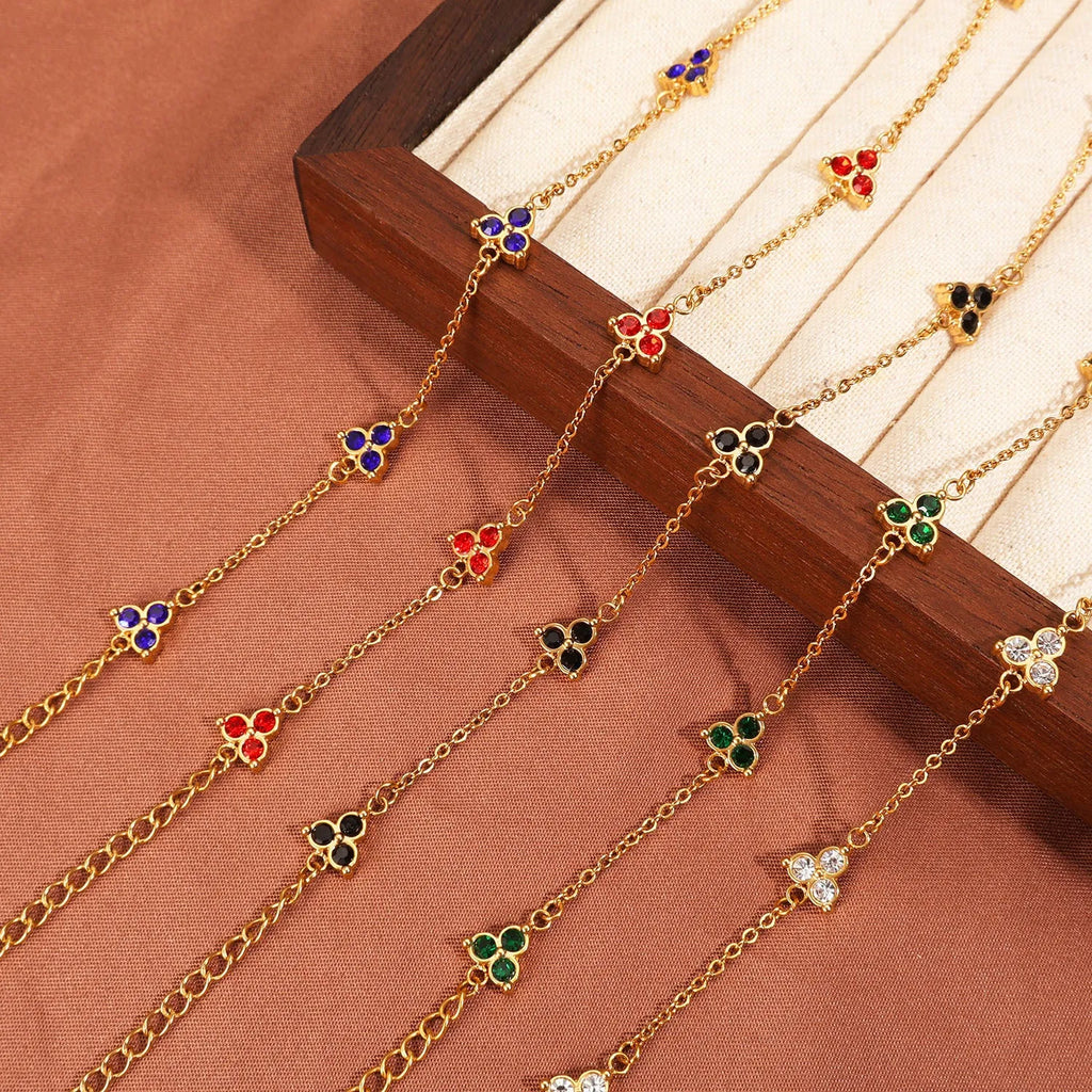 Women's geometric stainless steel bracelet with triple diamond design and coloured stone in gold or steel tone.