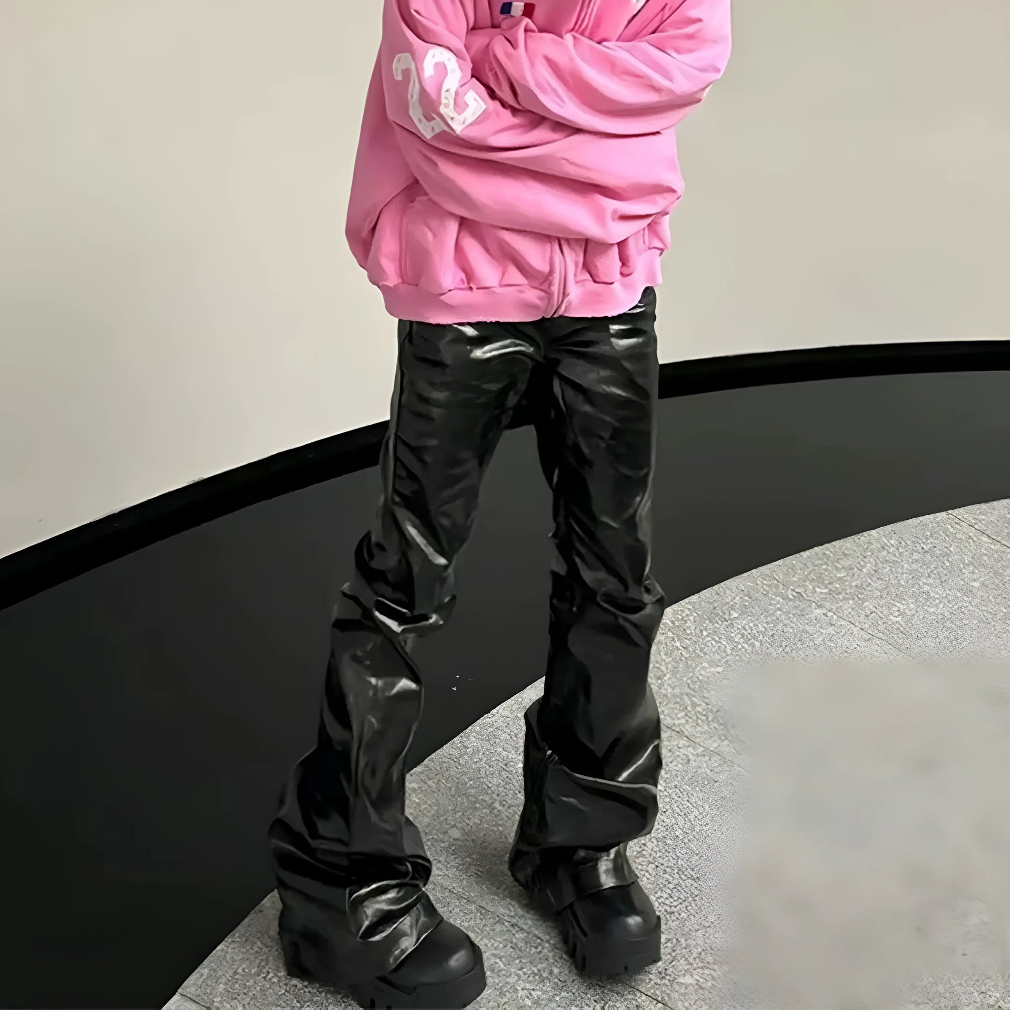 Black coated patent leather straight-leg skinny jeans on a hanger