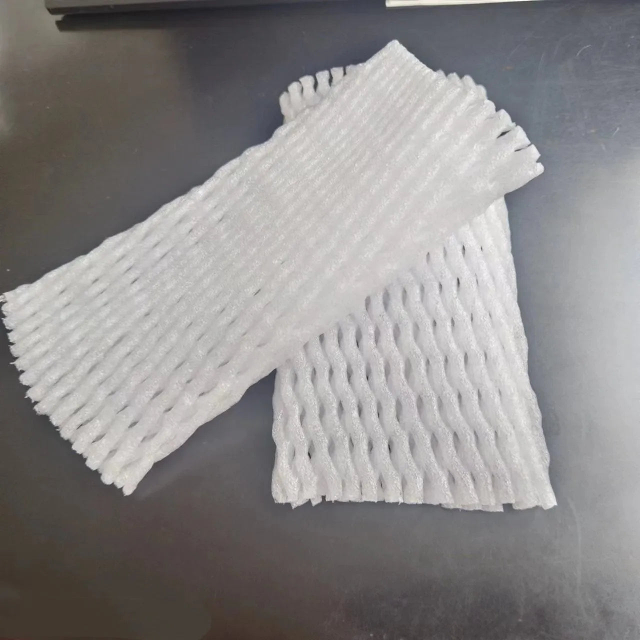 White foam net fruit protective cover shown in various sizes for packing.