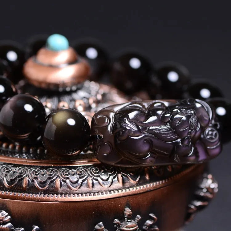Polished crystal Pi Xiu bracelet with Ice Stone design on a wrist, showing geometric ethnic style.