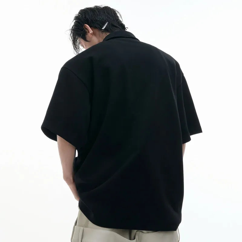 Men's grey polo shirt with a deconstructed multi-collar design and a geometric floral pattern on the front.