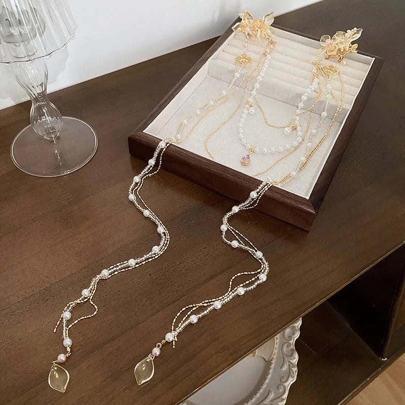 Gold women's hairpin with pearl, diamond flower and long tassel design