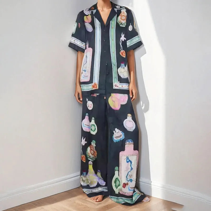 Women's black cartoon pattern holiday fashion set with trousers and cardigan-style top