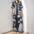 Women's black cartoon pattern holiday fashion set with trousers and cardigan-style top