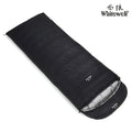 Black outdoor sleeping bag with envelope structure and goose down fill on a campsite.