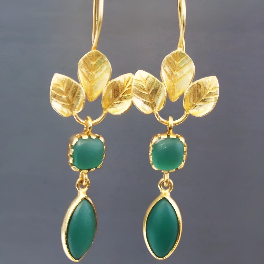 A pair of gold-colour drop earrings with French leaves, a tassel, and a zircon detail in a water droplet shape.