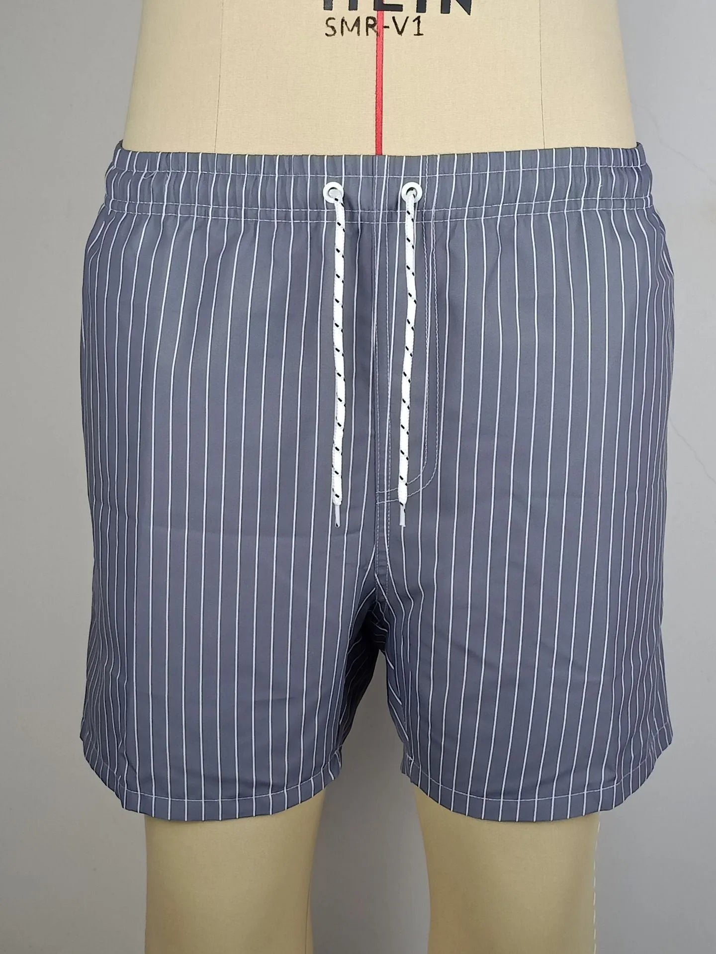 Men's striped beach shorts in navy blue, available in Asian sizes S to XXL with a straight-leg opening.