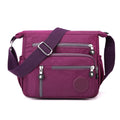 Soft nylon messenger bag in grey, shown as a square vertical model with a single shoulder strap.