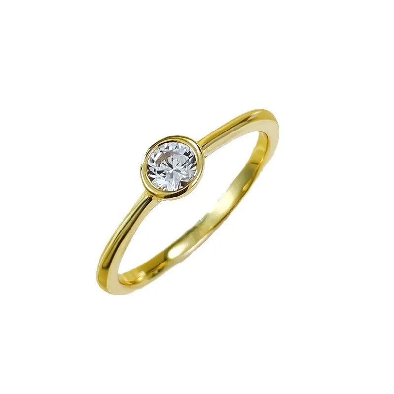 Minimalist silver women's ring with a crown shape and linear detailing in gold or platinum colour.
